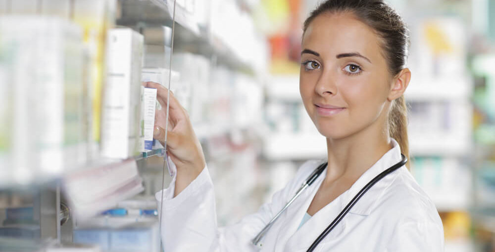A young female pharmacy technician working in a retail pharmacy setting